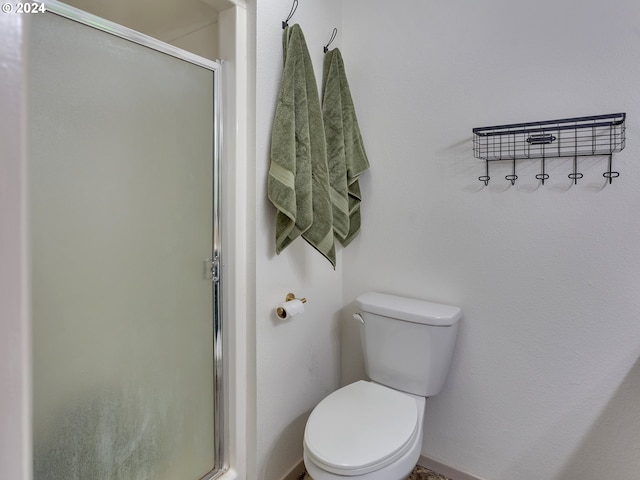 bathroom with an enclosed shower and toilet