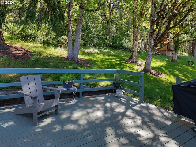 wooden terrace with a lawn