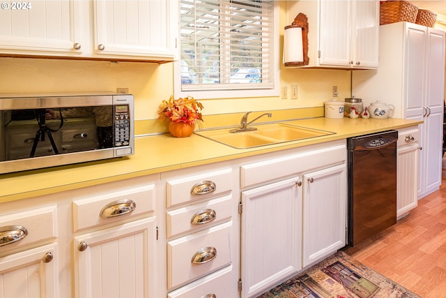 kitchen with white cabinets, dishwasher, light wood-type flooring, and sink