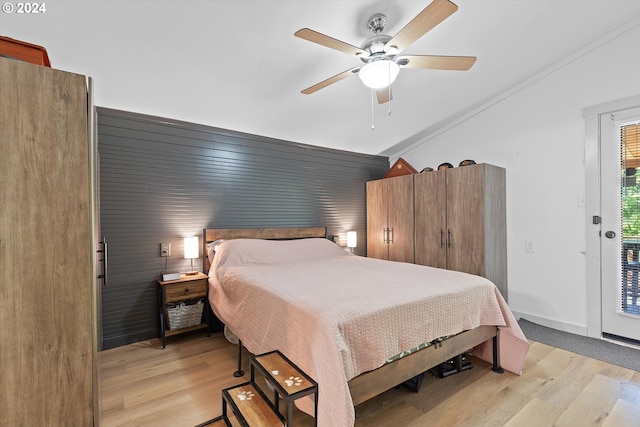 bedroom with a ceiling fan, lofted ceiling, light wood-style flooring, and baseboards