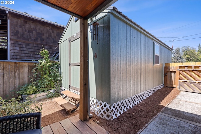 view of home's exterior featuring fence and an outdoor structure