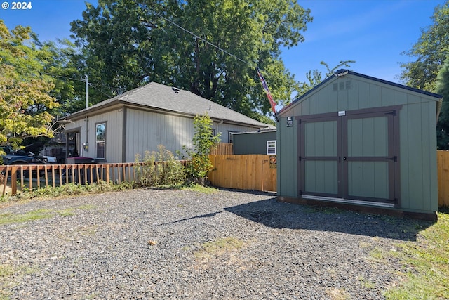 view of shed featuring fence