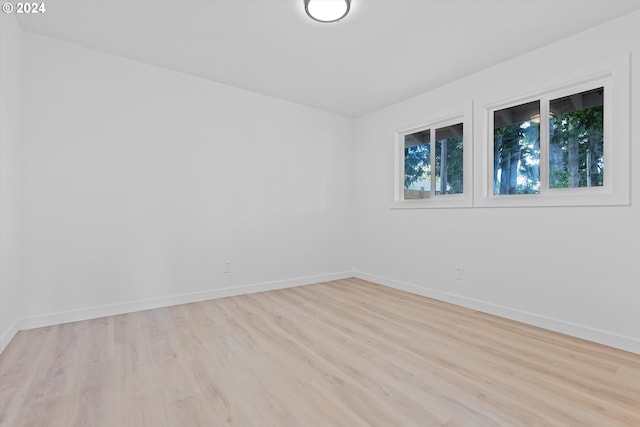 spare room with light hardwood / wood-style flooring