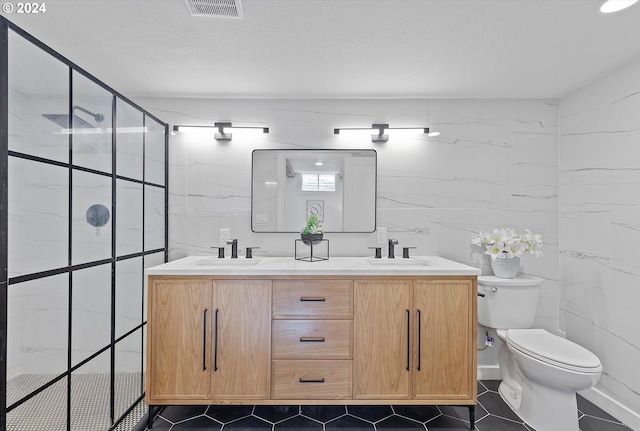 bathroom with vanity, toilet, tile walls, and a shower with shower door