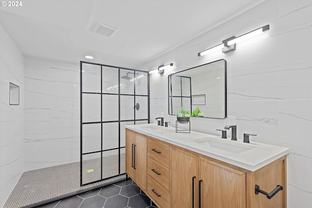 bathroom with vanity and tiled shower