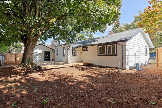 rear view of property featuring central AC