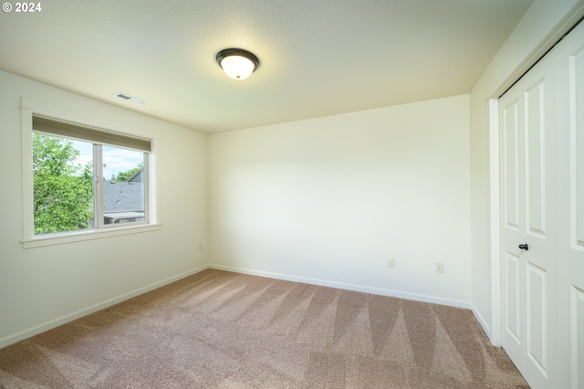 unfurnished bedroom with a closet and carpet floors