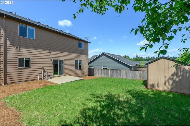 rear view of property featuring a storage shed and a yard