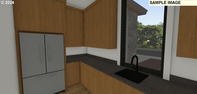 kitchen featuring white refrigerator and sink