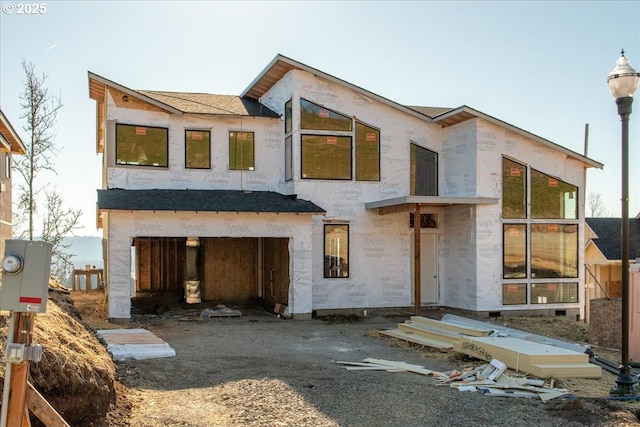 rear view of property with a garage