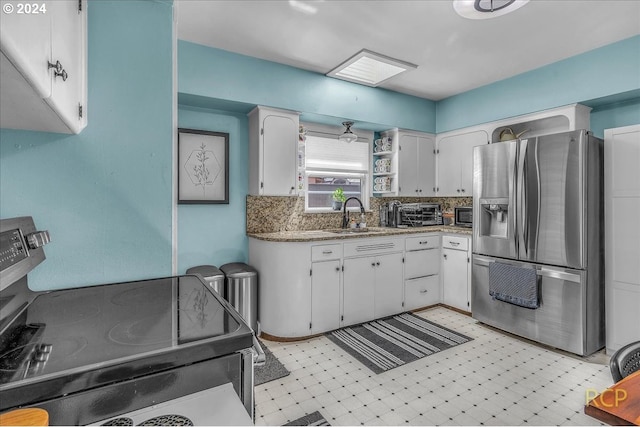 kitchen with white cabinetry, sink, decorative backsplash, and appliances with stainless steel finishes