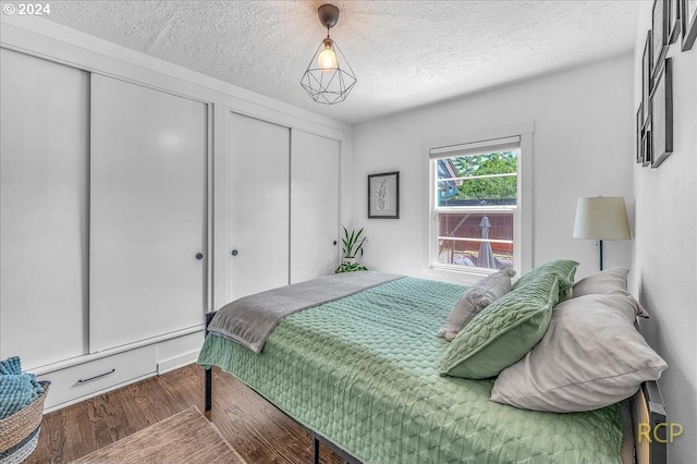 bedroom featuring wood-type flooring and a textured ceiling