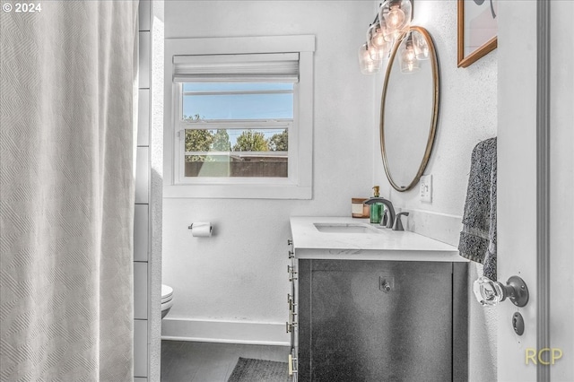 bathroom featuring vanity and toilet