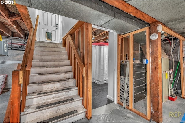 stairs with concrete flooring