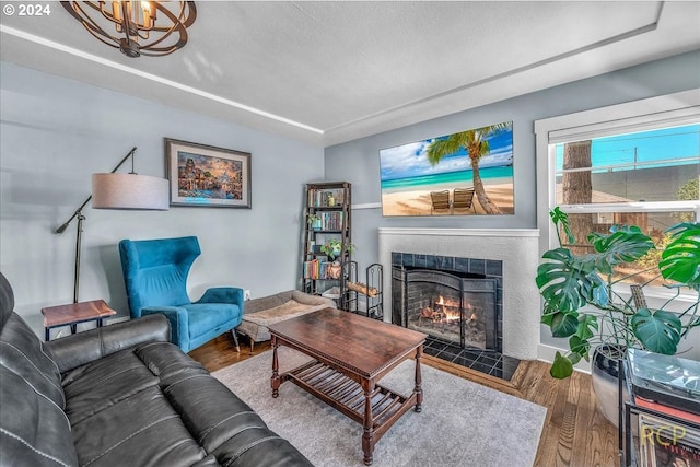 living room featuring hardwood / wood-style flooring and an inviting chandelier