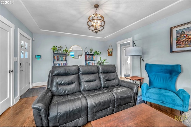 living room featuring wood-type flooring and a notable chandelier