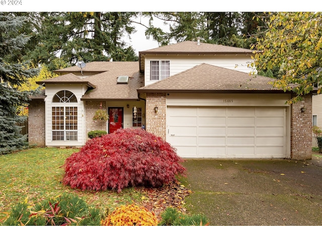 view of front of house with a front yard and a garage