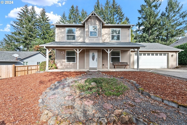 view of front of home featuring covered porch and a garage