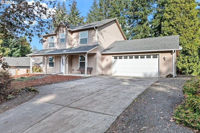 view of front facade with a garage and a porch