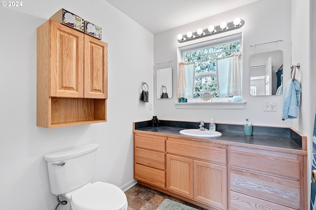 bathroom featuring vanity and toilet