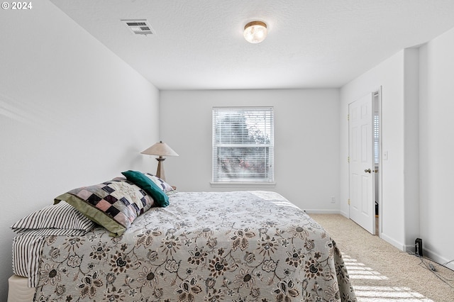 carpeted bedroom featuring a textured ceiling