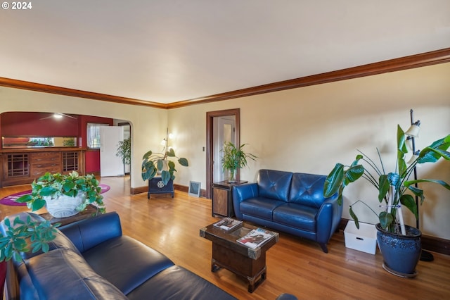 living room with hardwood / wood-style flooring and ornamental molding