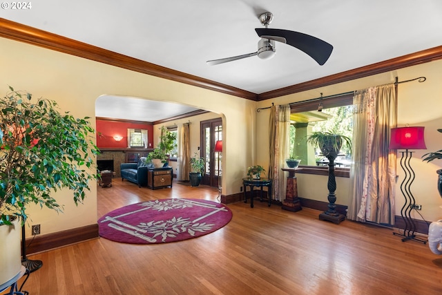 entryway with ceiling fan, hardwood / wood-style floors, and crown molding