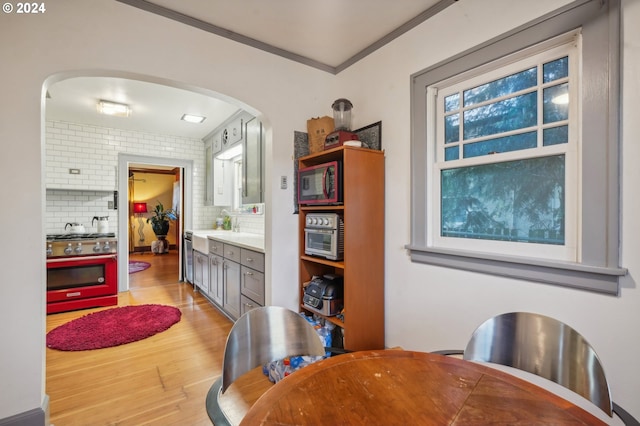 dining area featuring light hardwood / wood-style flooring and ornamental molding