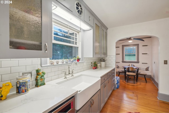 kitchen featuring gray cabinetry, sink, plenty of natural light, and light wood-type flooring