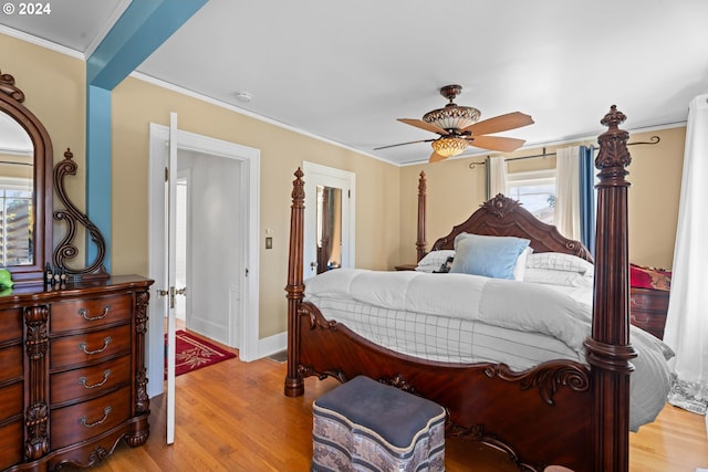 bedroom featuring ceiling fan, light hardwood / wood-style flooring, and crown molding