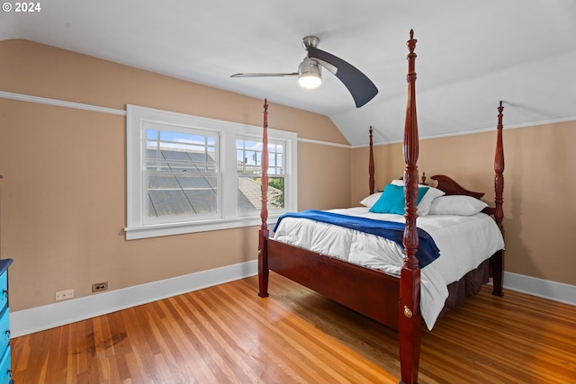 bedroom with hardwood / wood-style floors, vaulted ceiling, and ceiling fan