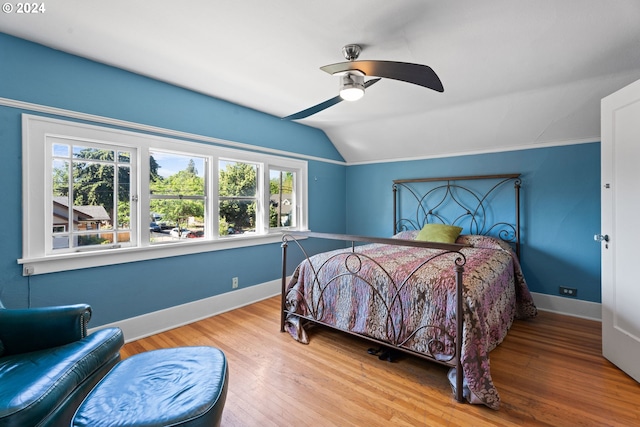 bedroom featuring ceiling fan, wood-type flooring, and vaulted ceiling