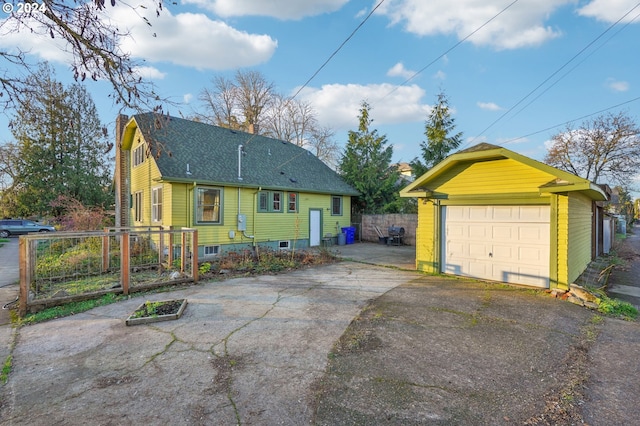 view of front facade featuring a garage and an outdoor structure