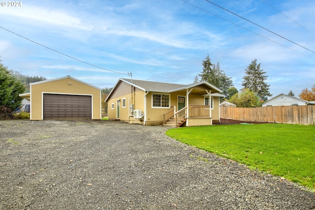 view of front facade featuring a garage, a front yard, and an outdoor structure