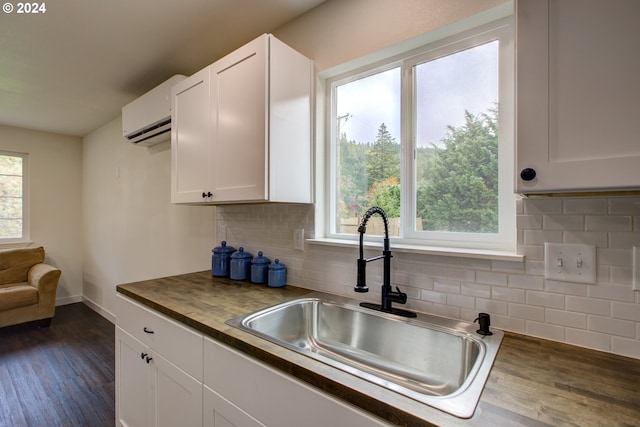 kitchen featuring white cabinets, a healthy amount of sunlight, and dark wood-type flooring