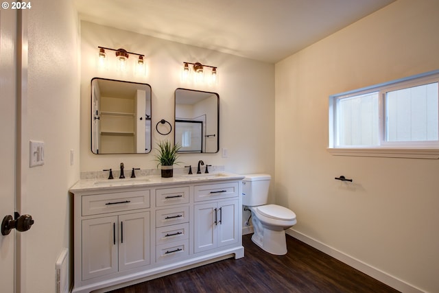 bathroom with hardwood / wood-style floors, vanity, and toilet