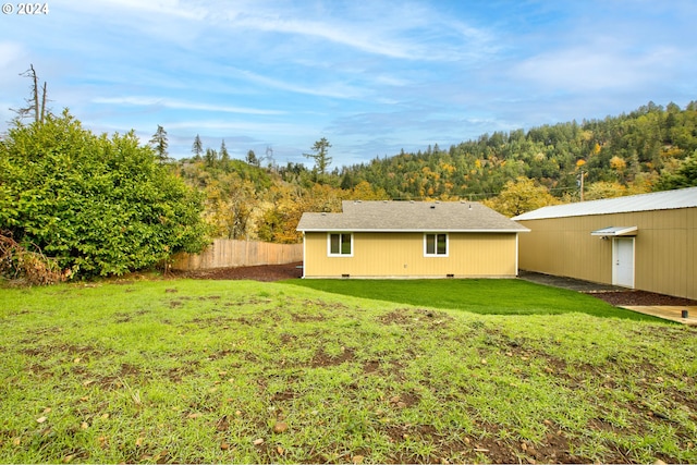 rear view of house with a lawn