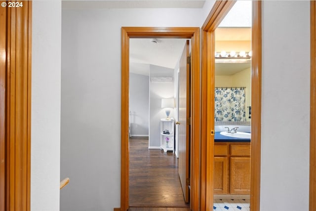 corridor featuring dark hardwood / wood-style floors and sink