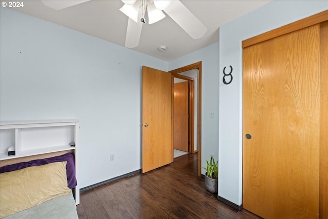 unfurnished bedroom featuring a closet, ceiling fan, and dark hardwood / wood-style flooring