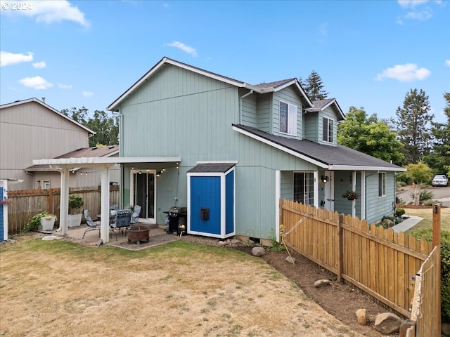 back of house with a lawn and a patio area