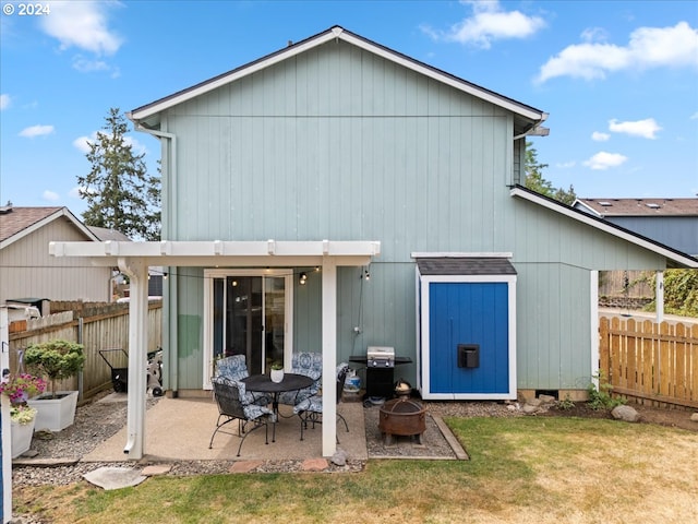 rear view of property featuring a lawn and a patio