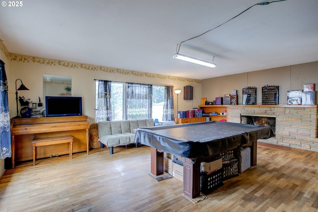 playroom with a fireplace, hardwood / wood-style floors, and billiards