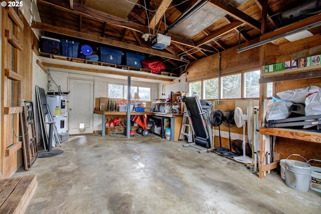 garage featuring water heater and a garage door opener