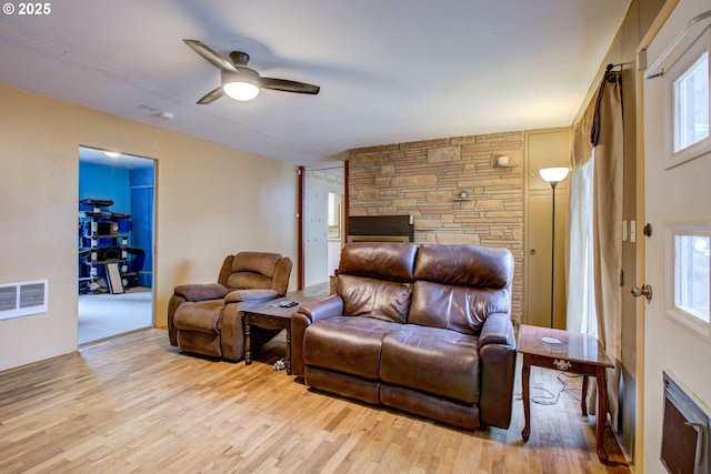 living room featuring light hardwood / wood-style flooring and ceiling fan