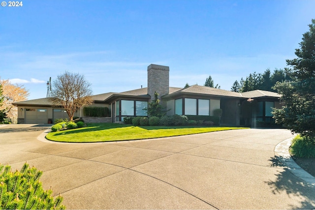 ranch-style home featuring a garage and a front lawn