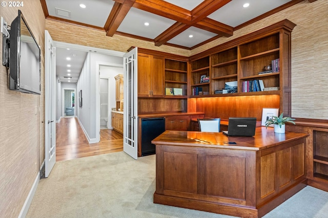 office space featuring light carpet, built in desk, coffered ceiling, and beamed ceiling