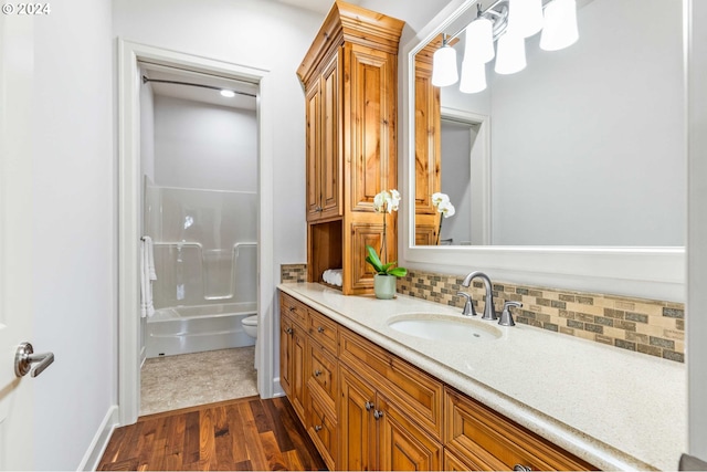 full bathroom with tile flooring, bathtub / shower combination, backsplash, toilet, and large vanity