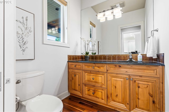 bathroom featuring hardwood / wood-style floors, toilet, and vanity