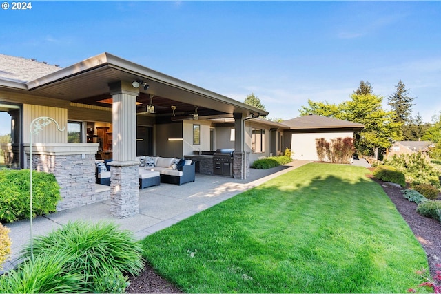 back of house featuring a patio area, a lawn, and an outdoor hangout area