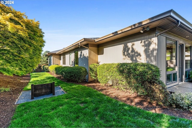 view of property exterior with a yard